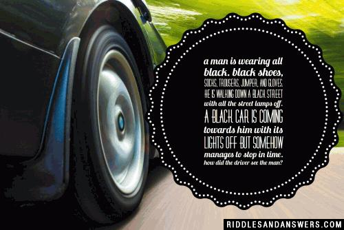 A man is wearing all black. Black shoes, socks, trousers, jumper, and gloves. He is walking down a black street with all the street lamps off. A black car is coming towards him with its lights off but somehow manages to stop in time.

How did the driver see the man?